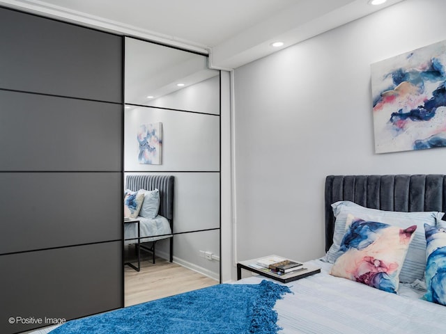 bedroom featuring wood finished floors and recessed lighting