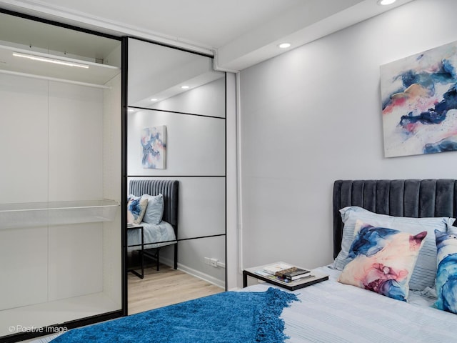 bedroom featuring wood finished floors and recessed lighting