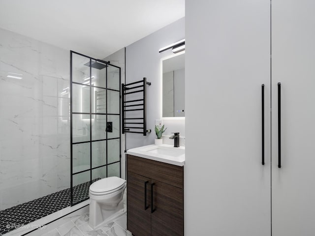 bathroom featuring a stall shower, marble finish floor, vanity, and toilet