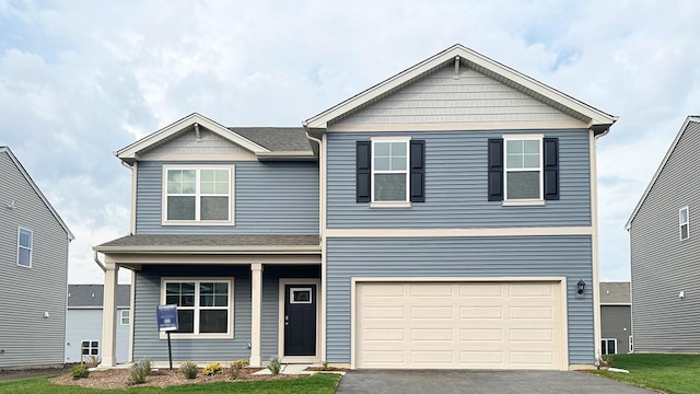 view of front of home with a garage and aphalt driveway