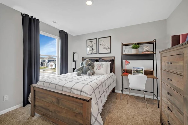 bedroom featuring light carpet and baseboards