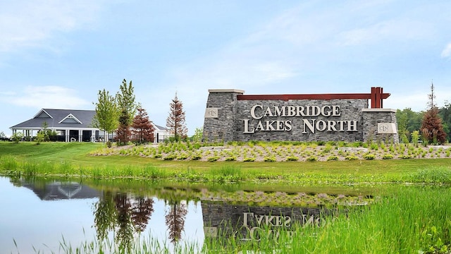 community sign featuring a water view