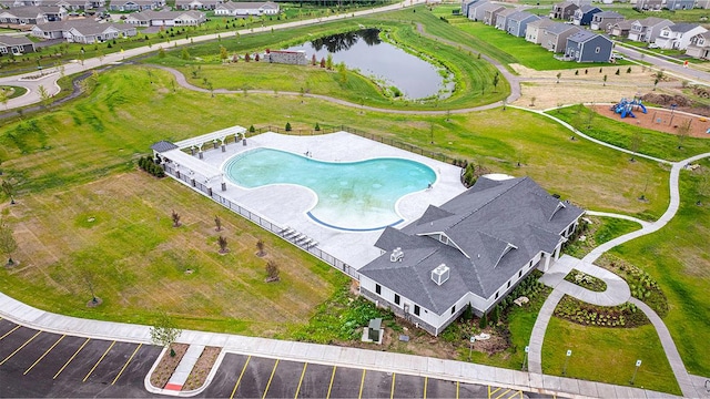 birds eye view of property with a water view and a residential view