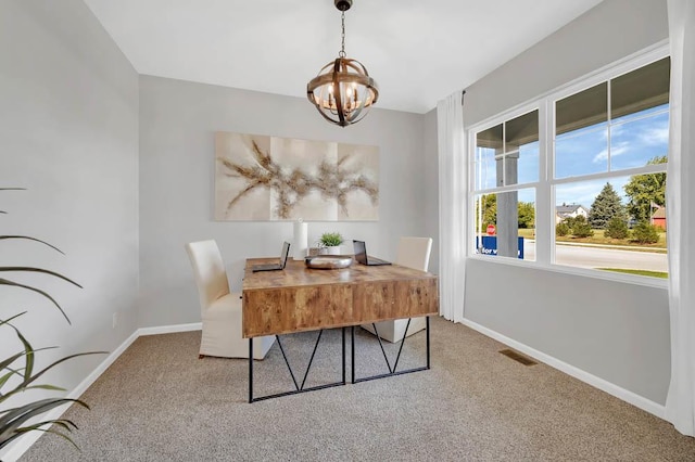 carpeted dining space featuring baseboards, visible vents, and a notable chandelier