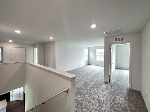 spare room featuring recessed lighting, visible vents, and baseboards