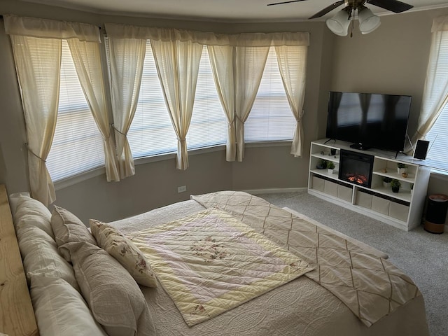 bedroom featuring carpet floors, baseboards, and a ceiling fan