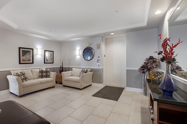 living area with a tray ceiling, recessed lighting, and baseboards