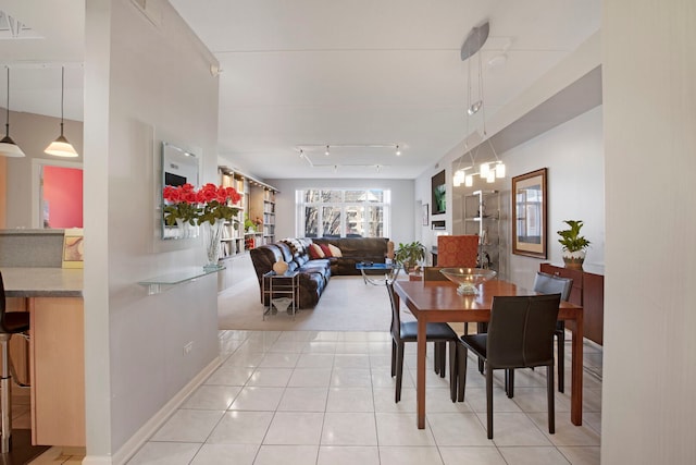 dining area with light tile patterned floors and rail lighting