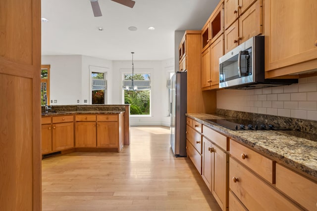 2806 Oakmont Ct, Champaign, IL 61821 - kitchen featuring appliances with stainless steel finishes, light wood-style floors, decorative backsplash, ceiling fan, and decorative light fixtures
