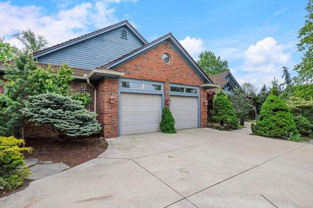 2806 Oakmont Ct, Champaign, IL 61821 - view of side of home featuring brick siding, driveway, and a garage
