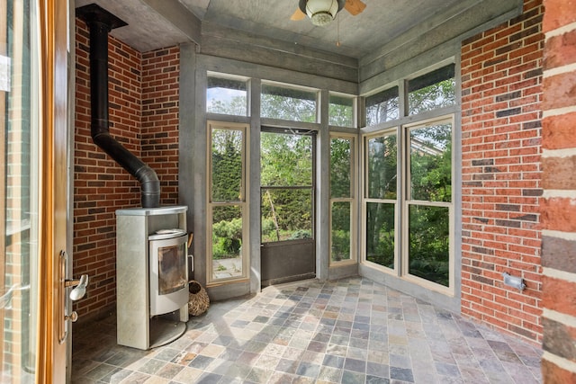 2806 Oakmont Ct, Champaign, IL 61821 - unfurnished sunroom with a wood stove, plenty of natural light, and a ceiling fan