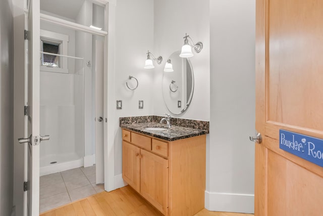 2806 Oakmont Ct, Champaign, IL 61821 - bathroom with vanity, a shower, baseboards, and wood finished floors
