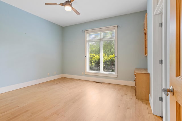 2806 Oakmont Ct, Champaign, IL 61821 - spare room featuring light wood-style flooring, a ceiling fan, and baseboards