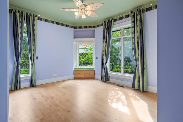 2806 Oakmont Ct, Champaign, IL 61821 - empty room featuring a ceiling fan and wood finished floors