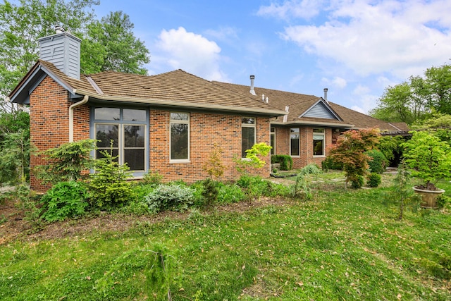 2806 Oakmont Ct, Champaign, IL 61821 - rear view of property with brick siding, a chimney, and a lawn