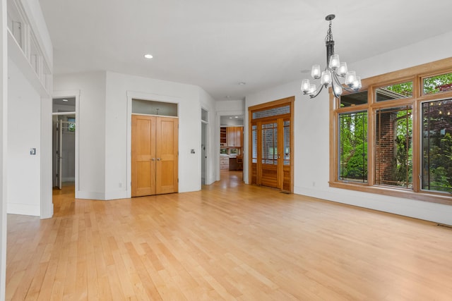 2806 Oakmont Ct, Champaign, IL 61821 - unfurnished living room featuring a chandelier, light wood-type flooring, recessed lighting, and baseboards