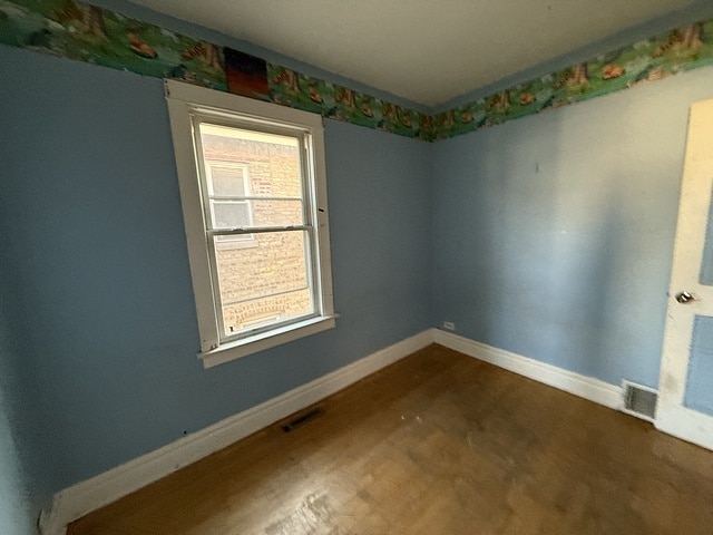 unfurnished room featuring visible vents and baseboards