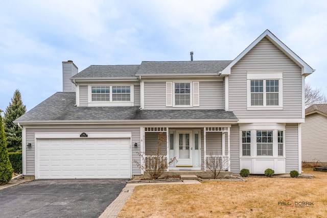 traditional home featuring driveway, a shingled roof, a chimney, a porch, and a front yard