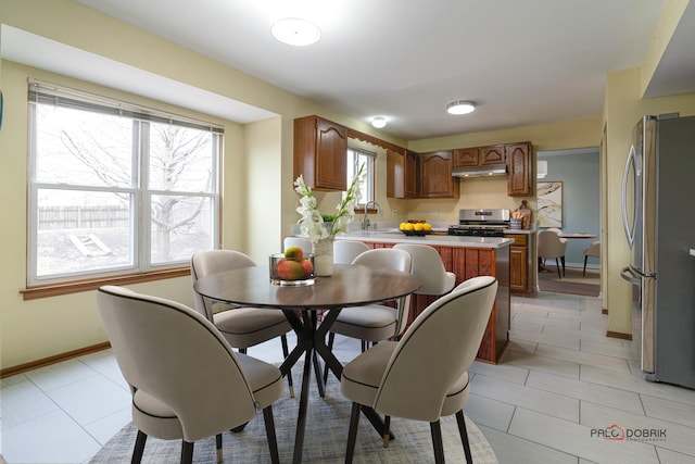 dining room with baseboards and light tile patterned flooring