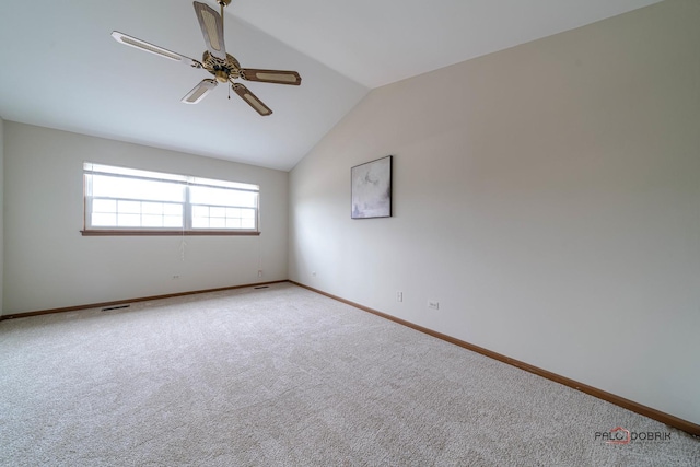 empty room with carpet floors, ceiling fan, baseboards, and lofted ceiling