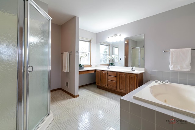 full bathroom with a whirlpool tub, a shower stall, double vanity, and a sink