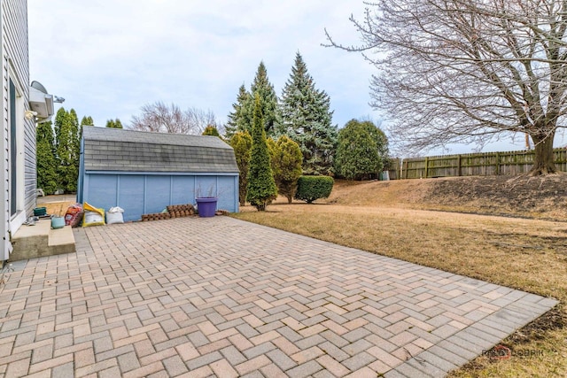 view of patio featuring an outbuilding and fence