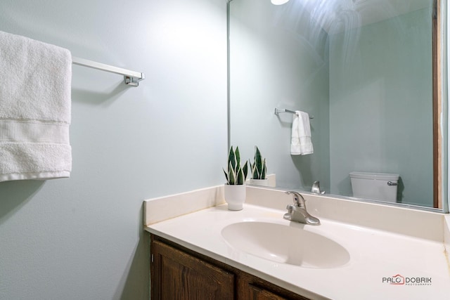 bathroom featuring toilet and vanity