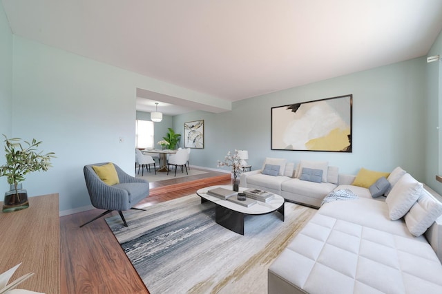 living area featuring baseboards and wood finished floors