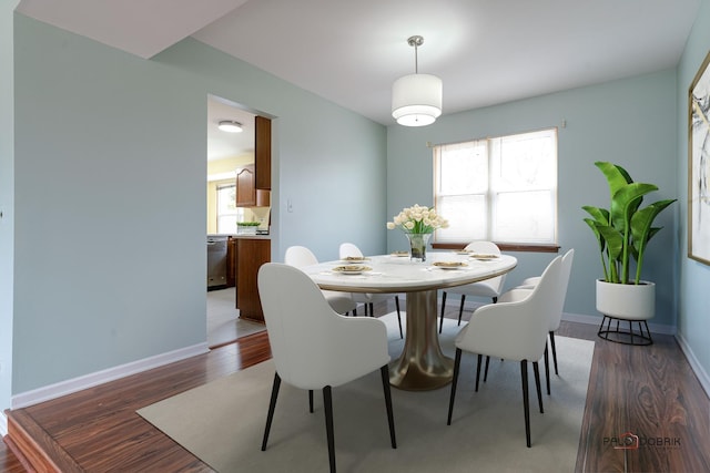 dining area with plenty of natural light, wood finished floors, and baseboards