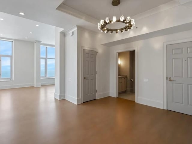 unfurnished dining area featuring a healthy amount of sunlight, baseboards, concrete flooring, and recessed lighting