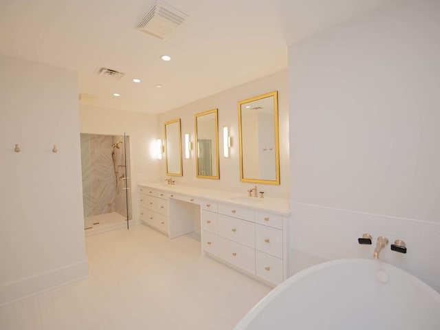 bathroom featuring double vanity, a stall shower, a sink, and visible vents