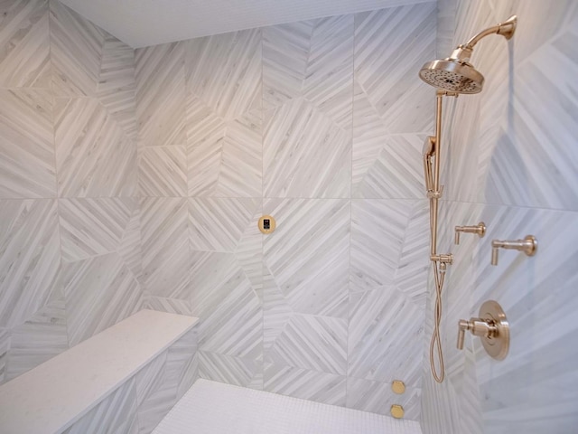 bathroom with a tile shower