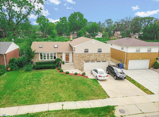 tri-level home with driveway, stone siding, an attached garage, and a front yard