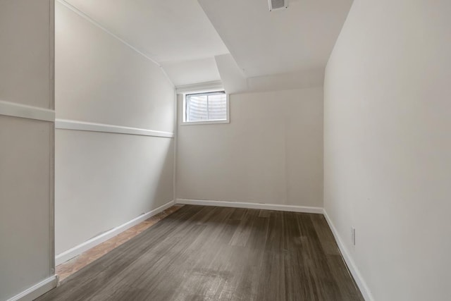 additional living space featuring visible vents, baseboards, and wood finished floors