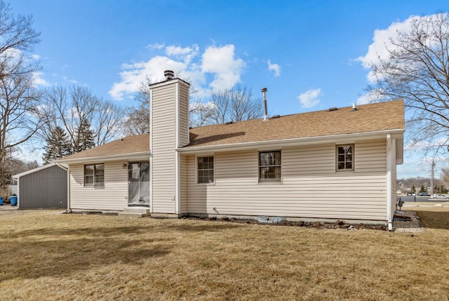 back of property with a yard, a chimney, and roof with shingles