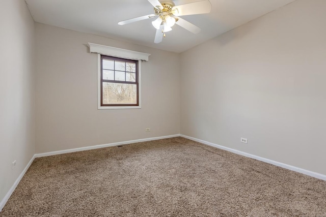 spare room with a ceiling fan, carpet, and baseboards