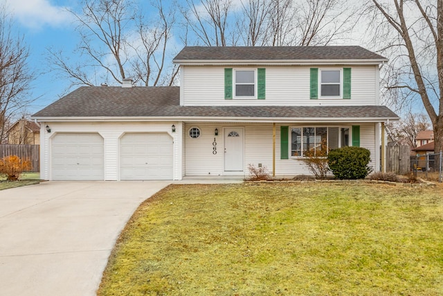 traditional home with a garage, driveway, fence, and a front yard