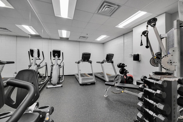 workout area with visible vents and a drop ceiling