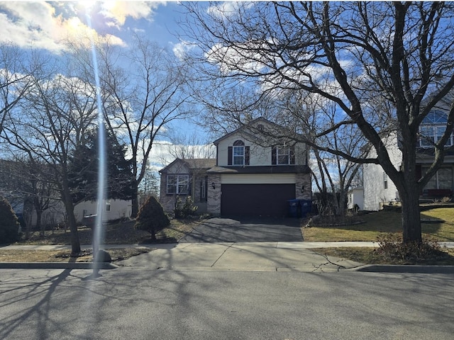 view of front of house featuring a garage, driveway, and brick siding