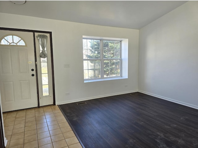 entrance foyer with baseboards, visible vents, and tile patterned floors