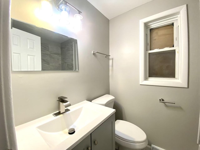 bathroom featuring toilet and vanity