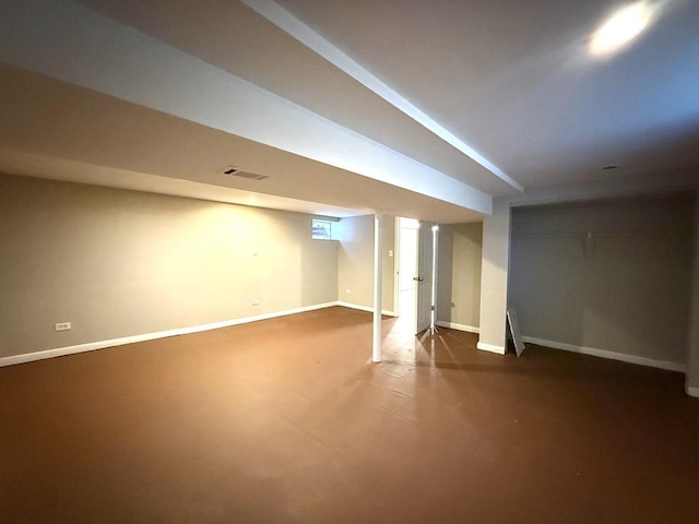 finished basement featuring baseboards and visible vents