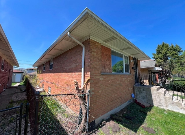 view of home's exterior featuring fence and brick siding