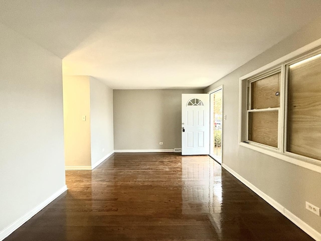 interior space featuring baseboards and wood finished floors