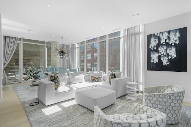 living area featuring recessed lighting, floor to ceiling windows, a notable chandelier, and wood finished floors