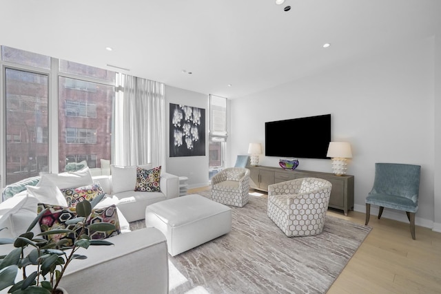 living area featuring recessed lighting, wood finished floors, and baseboards