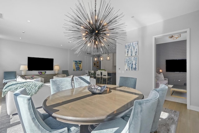 dining space featuring light wood finished floors, visible vents, a notable chandelier, and recessed lighting