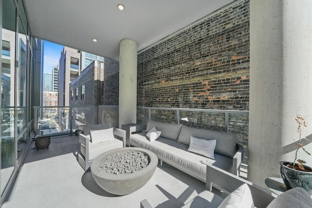 view of patio with a balcony, an outdoor hangout area, and a city view