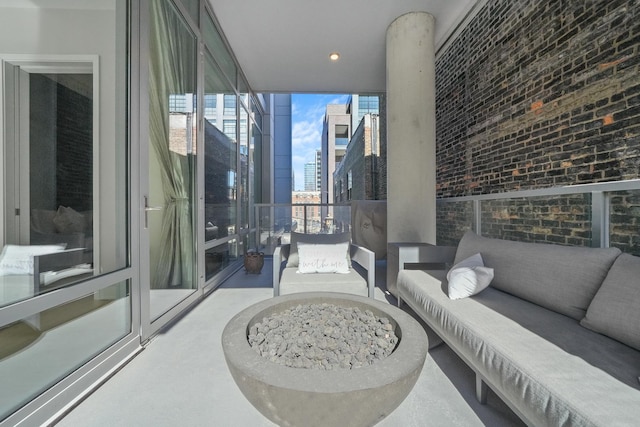 interior space with a balcony, a view of city, and an outdoor living space