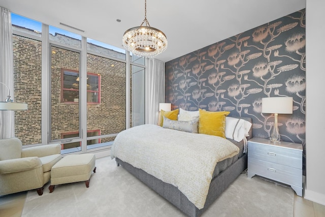 bedroom featuring expansive windows, visible vents, a notable chandelier, and wallpapered walls